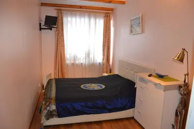a small bedroom with a bed and a window at Danarent Apartment in Vilnius
