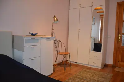a bedroom with a desk and a chair and a mirror at Danarent Apartment in Vilnius