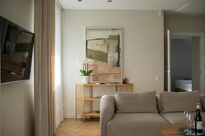 a living room with a couch and a table at The Elegant Escape in Šiauliai