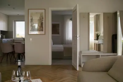 a living room with a couch and a dining room at The Elegant Escape in Šiauliai
