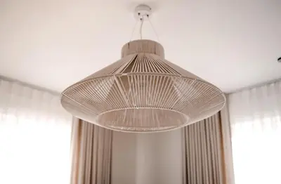 a large glass light fixture hanging from a ceiling at The Elegant Escape in Šiauliai