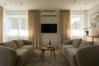 a living room with two couches and a table at The Elegant Escape in Šiauliai