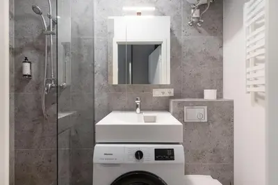 a bathroom with a sink and a shower at Hook Studios Vilnius Old Town Economy in Vilnius