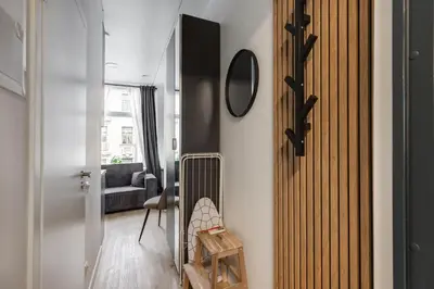 a living room with a radiator and a chair at Hook Studios Vilnius Old Town Economy in Vilnius