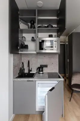 a kitchen with a sink and a microwave at Hook Studios Vilnius Old Town Economy in Vilnius