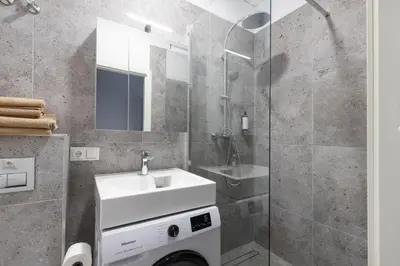 a bathroom with a sink and a shower at Hook Studios Vilnius Old Town Economy in Vilnius