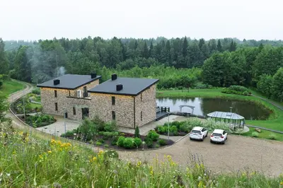 an aerial view of a house with two cars parked at Sabos Rezidencija Private Countryside Villa near Vilnius in Dzenkuniskes