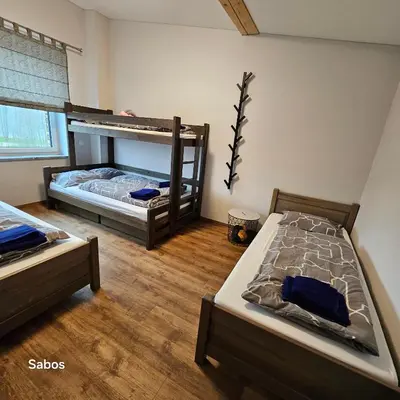two bunk beds in a room with wooden floors at Sabos Rezidencija Private Countryside Villa near Vilnius in Dzenkuniskes