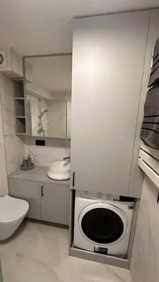a kitchen with a washing machine in a bathroom at Sunny loft 24x7 x free parking x close to old town by H&H in Vilnius