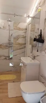 a bathroom with a toilet and a sink at Sodyba Narūnas VIP namelis in Sponėnai