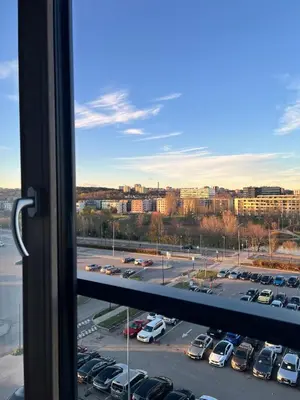 a view from a window of a parking lot at Ozo Parko Butas in Vilnius