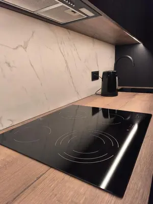 a kitchen with a black and white counter and a table at Ozo Parko Butas in Vilnius