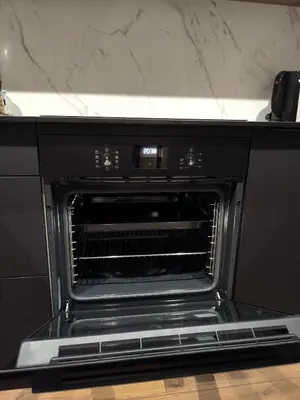 a black oven with its door open in a kitchen at Ozo Parko Butas in Vilnius