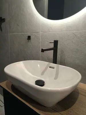 a white sink in a bathroom with a mirror at Ozo Parko Butas in Vilnius