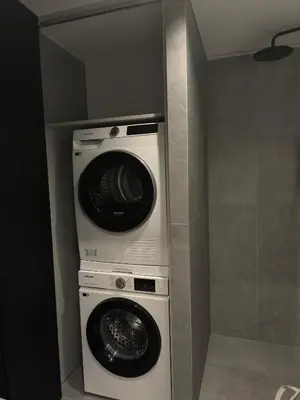 two washing machines and a washer and dryer in a bathroom at Ozo Parko Butas in Vilnius
