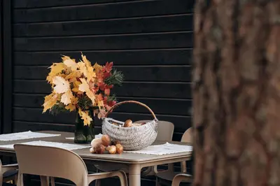 a table with a basket and a vase with flowers at Gamtos pinklės in Žiūrai