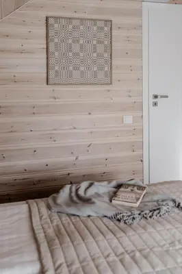 a bedroom with a bed with a picture on the wall at Gamtos pinklės in Žiūrai