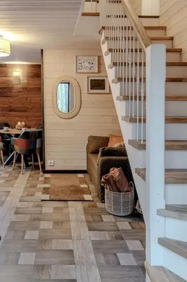 a living room with stairs and a table at Gamtos pinklės in Žiūrai