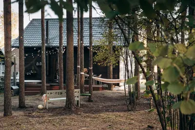 a playground in front of a house with a bench at Gamtos pinklės in Žiūrai