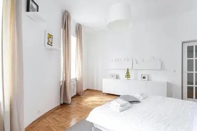 a white bedroom with a white bed and a window at Cosy and bright Saint Ignoto Apartment by Reside Baltic in Vilnius