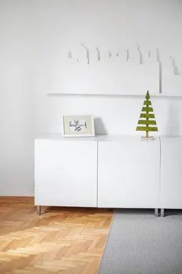 a white desk with a christmas tree on top of it at Cosy and bright Saint Ignoto Apartment by Reside Baltic in Vilnius