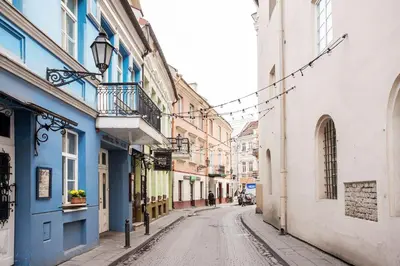 an empty street with blue and white buildings at Cosy and bright Saint Ignoto Apartment by Reside Baltic in Vilnius