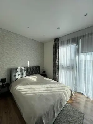 a bedroom with a large bed and a window at Kaunorama apartamentai prie Žalgirio arenos in Kaunas