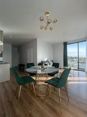 a kitchen and dining room with a table and chairs at Kaunorama apartamentai prie Žalgirio arenos in Kaunas