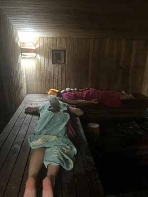 two people laying on the floor of a bunk bed at Milky Way House in Karvys