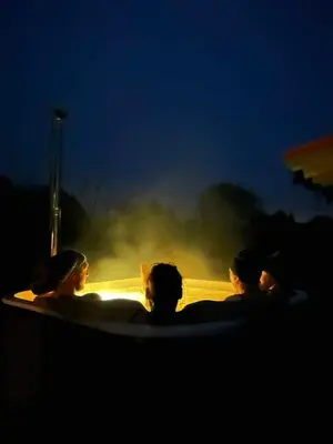 a group of people in a hot tub at night at Milky Way House in Karvys