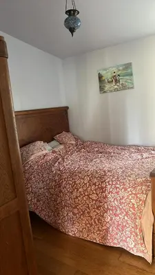 a bedroom with a bed with a red comforter at Milky Way House in Karvys