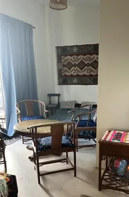 a room with a table and chairs and a rug at Milky Way House in Karvys