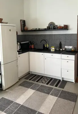 a kitchen with white cabinets and a white refrigerator at Milky Way House in Karvys