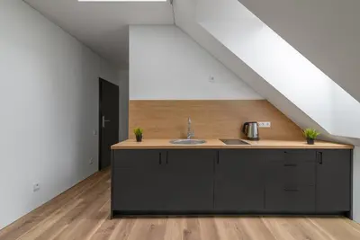a kitchen with a sink in a attic at Restart in Kaunas