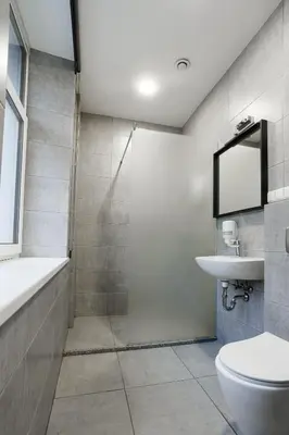 a bathroom with a shower and a toilet and a sink at Restart in Kaunas