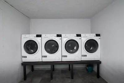 three washing machines sitting on a table in a room at Restart in Kaunas