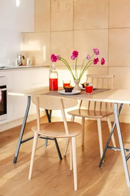 a table with two chairs and a table with flowers on it at Angel House Vilnius 37 in Vilnius