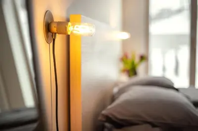 a light on a wall next to some pillows at Angel House Vilnius 37 in Vilnius