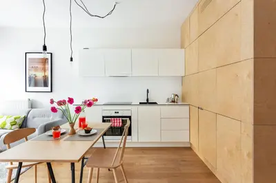 a kitchen and dining room with a table and chairs at Angel House Vilnius 37 in Vilnius