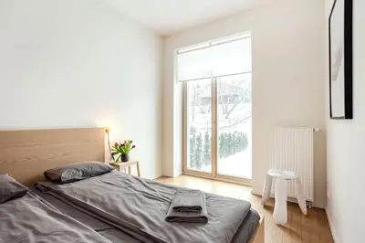 a bedroom with a bed and a large window at Angel House Vilnius 37 in Vilnius