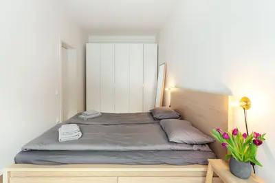 a bedroom with a large bed with a white cabinet at Angel House Vilnius 37 in Vilnius
