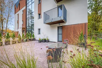 a house with a balcony on the side of it at Birstonas Rent in Birštonas