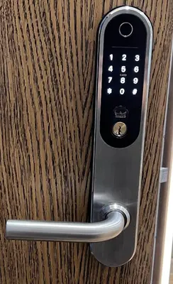 a remote control sticking out of a wooden door at Birstonas Rent in Birštonas