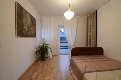 a bedroom with a bed and a potted plant at Vilnius Luxury Apartment 1 in Vilnius
