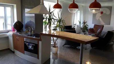 a kitchen with a counter and a table and chairs at Vilnius Luxury Apartment 1 in Vilnius