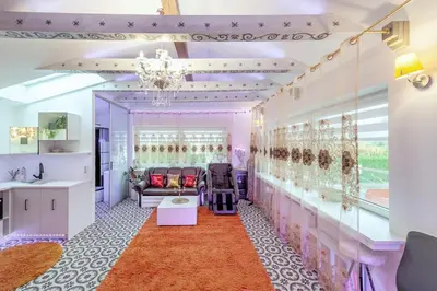 a dressing room with pink walls and a chandelier at Villa SPA in Vilnius