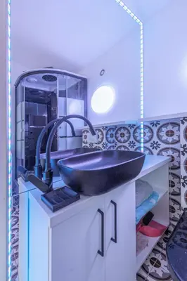 a bathroom with a black sink and a mirror at Villa SPA in Vilnius