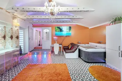 a large bathroom with a tub and a chandelier at Villa SPA in Vilnius