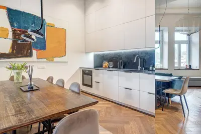 a kitchen with a wooden table and a dining room at Boutique apartment in Old Town in Vilnius