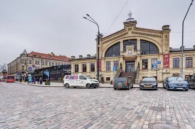a group of cars parked in front of a building at Boutique apartment in Old Town in Vilnius